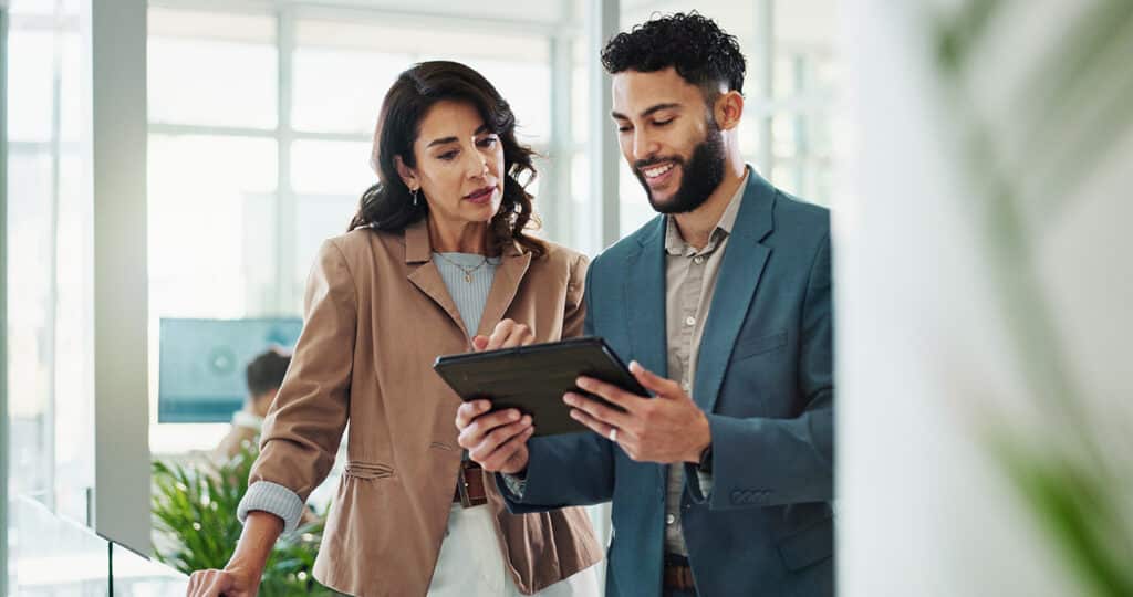 Business people in office using tablet for research.